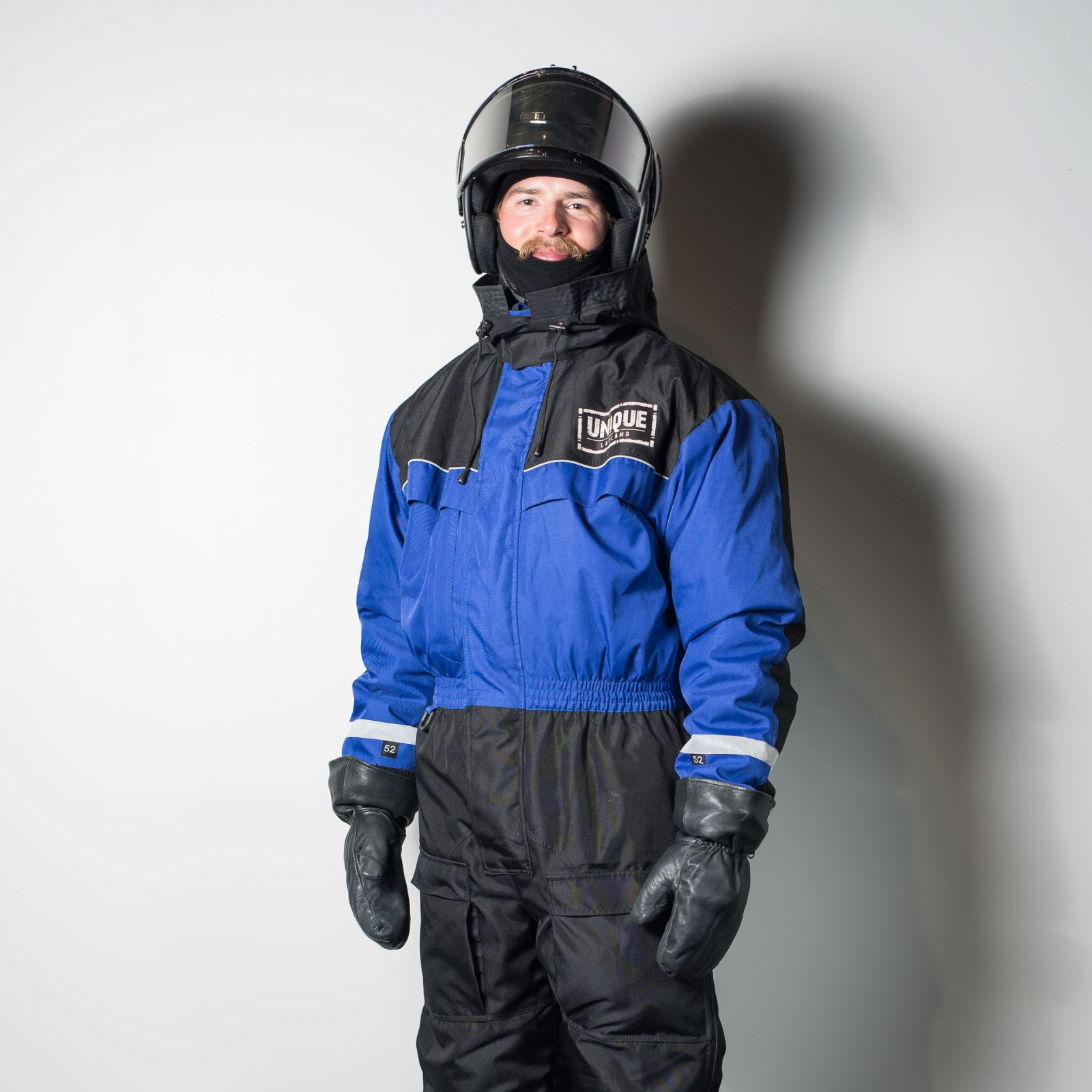 Man wearing winter overall suit with snowmobile helmet