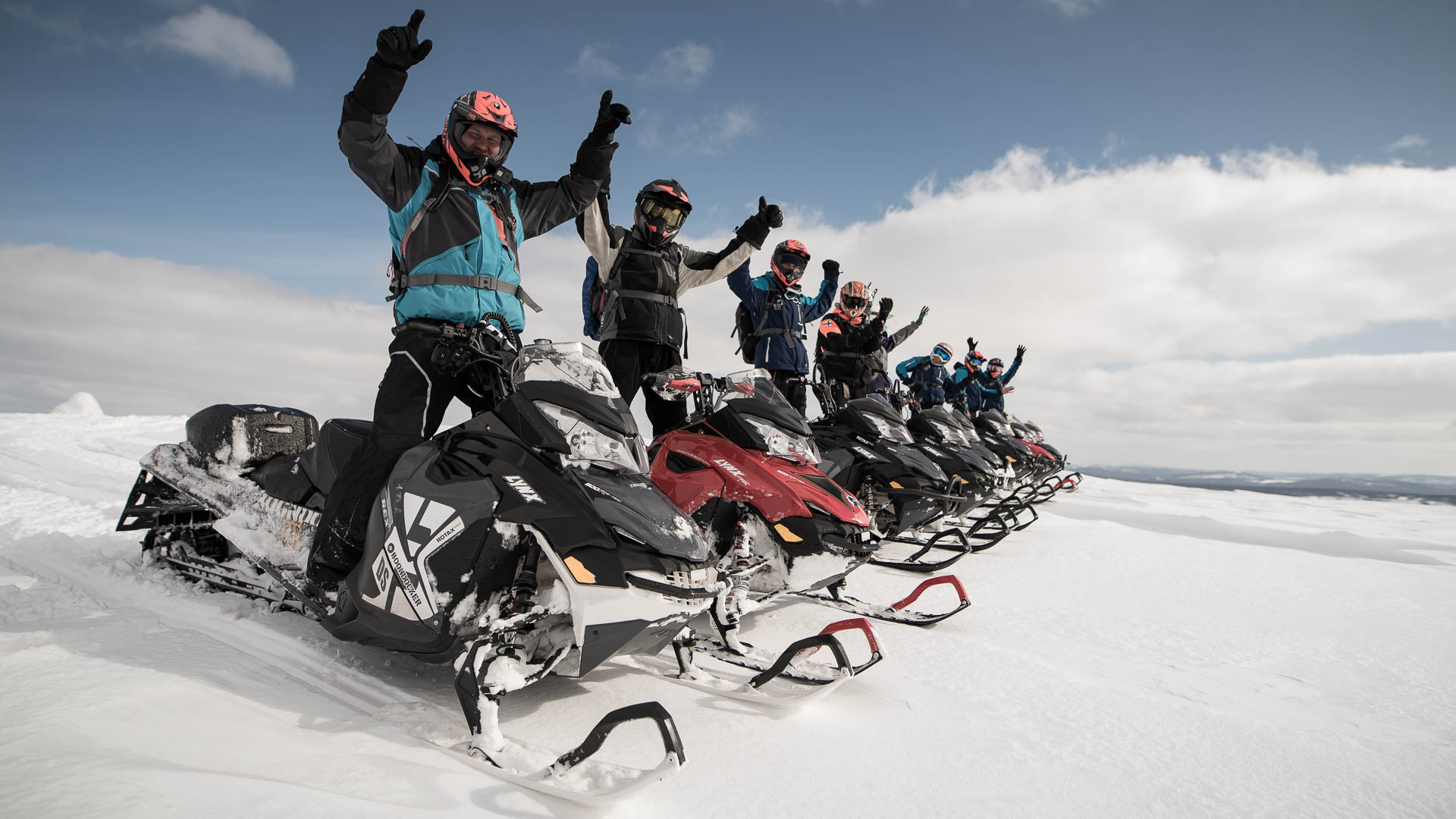 Many people cheering while standing on snowmobiles. Rovaniemi / Arctic Expeditions – Wild Nordic Finland @wildnordicfinland