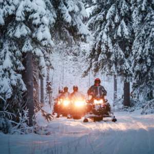 Tourists on an easy snowmobile safari with Wild Nordic Finland in Rovaniemi, Lapland