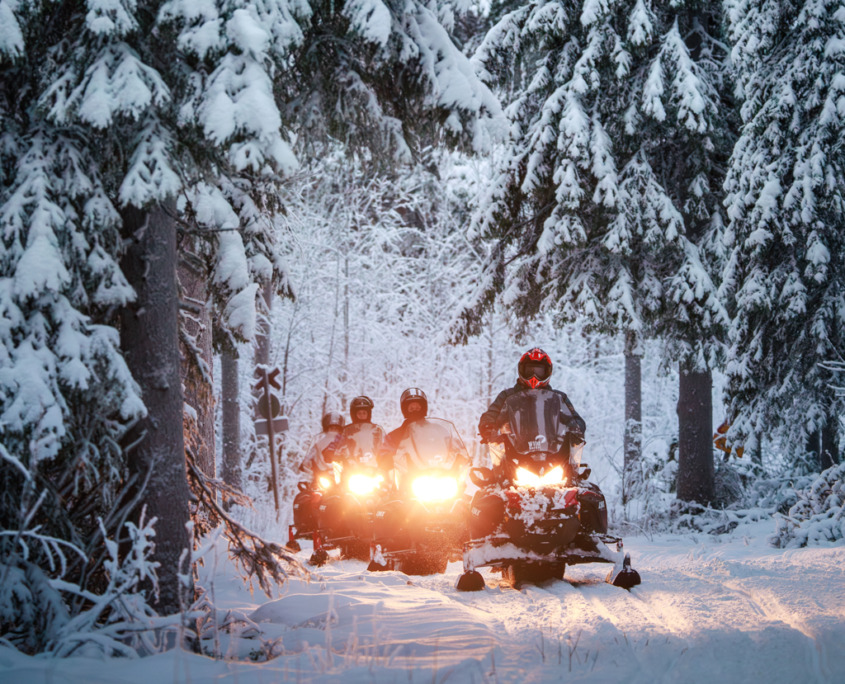 Tourists on an easy snowmobile safari with Wild Nordic Finland in Rovaniemi, Lapland
