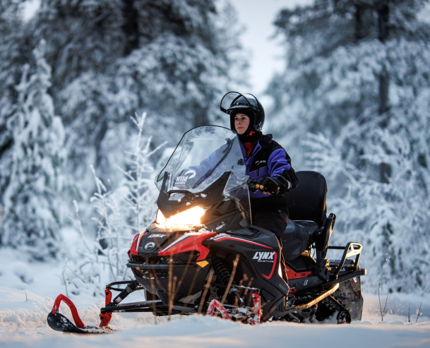 Tourist on an easy snowmobile tour with Wild Nordic Finland in Rovaniemi, Lapland